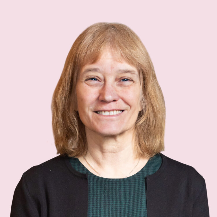 Women smiling, surrounding by pink background.
