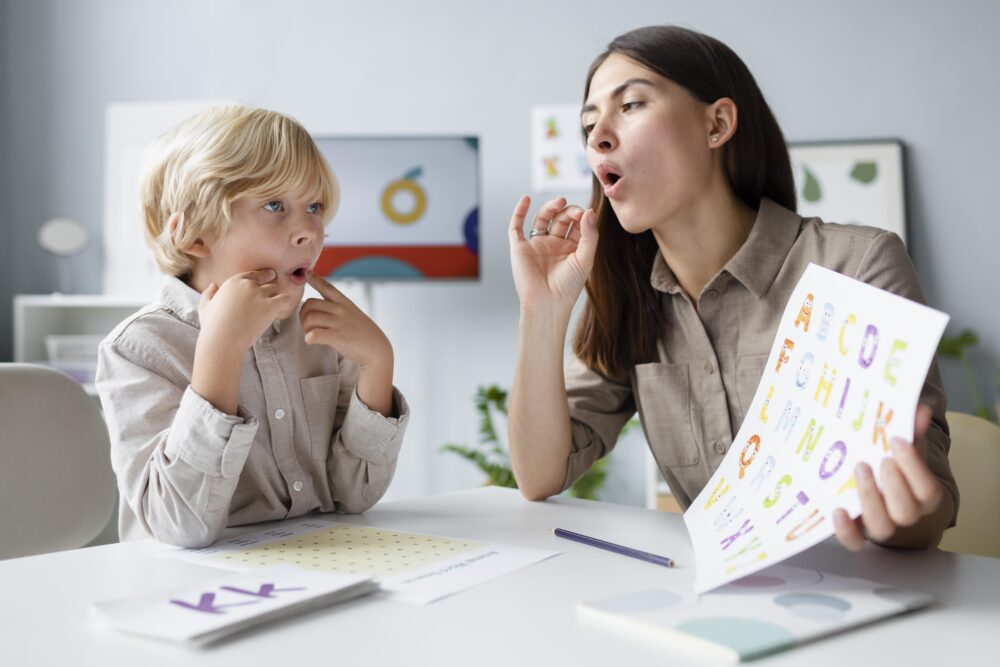 Speech and language therapist demonstrating speech sounds with a child.